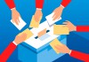 Voting hands and ballot box